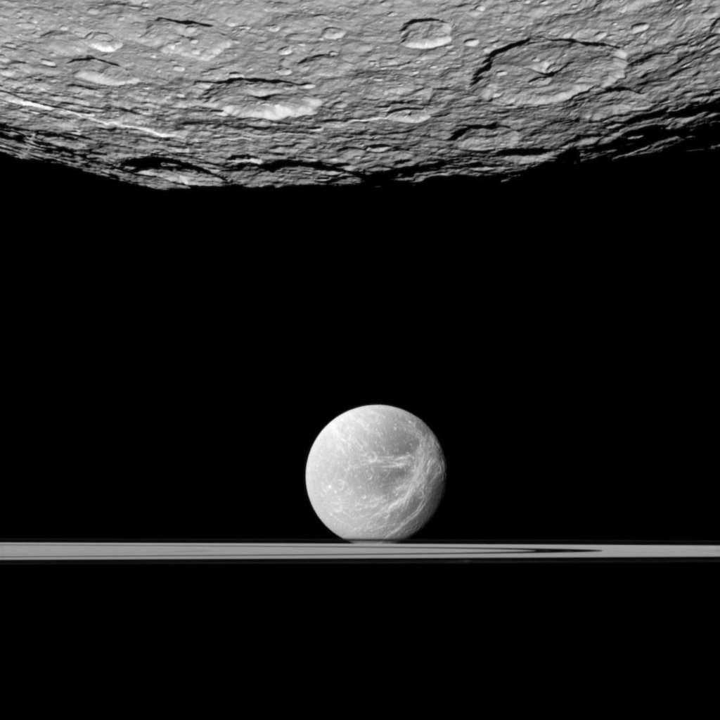 Saturn's rings with moons Titan and Thethys. dpa