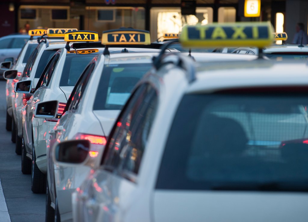 Taxen stehen am 29.06.2015 in Berlin am Abend am Flughafen Tegel. Foto: Paul Zinken/dpa