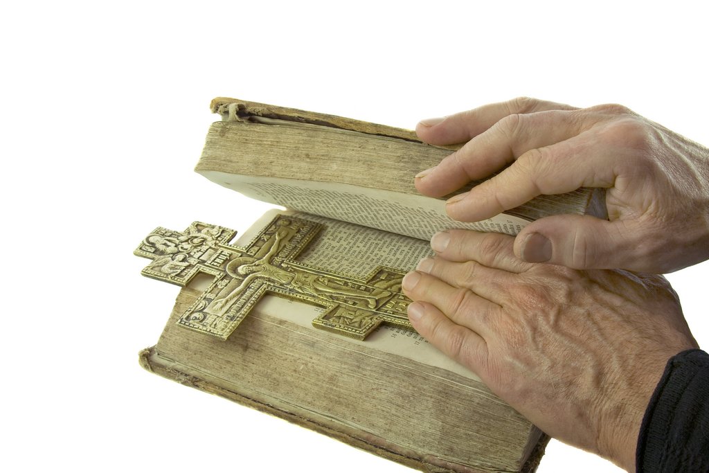 Male hand closed the bible /@depositphotos